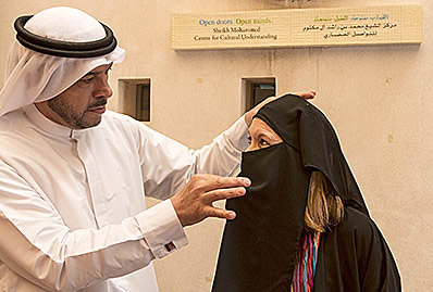 visitor-tries-on-traditional-muslim-dress-at-cultural-center