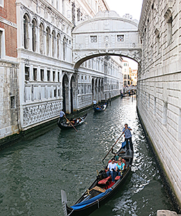 Venice gondola traveling a side canal
