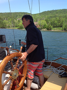 Captain John steering the Amoeba schooner