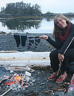 Kayaker drying socks over the campfire