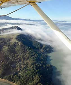 Seaplane flying toward fog