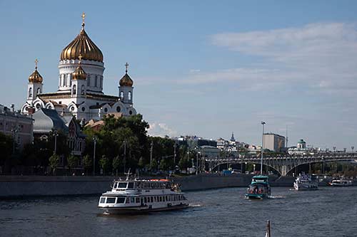 Cruising the Moskva River past golden domed cathedral