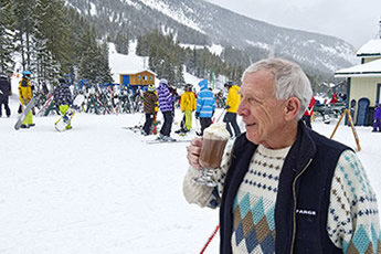 Castle Mountain skier with hot chocolate