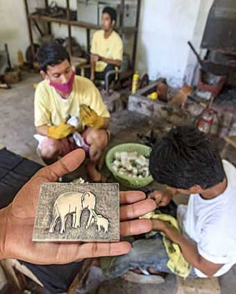 Artisan Angkor, a workshop that trains young, uneducated and sometimes disabled Cambodian youths in craftwork including wood carving, lacquerware, silver work and silk painting. Here, young men work on silver.